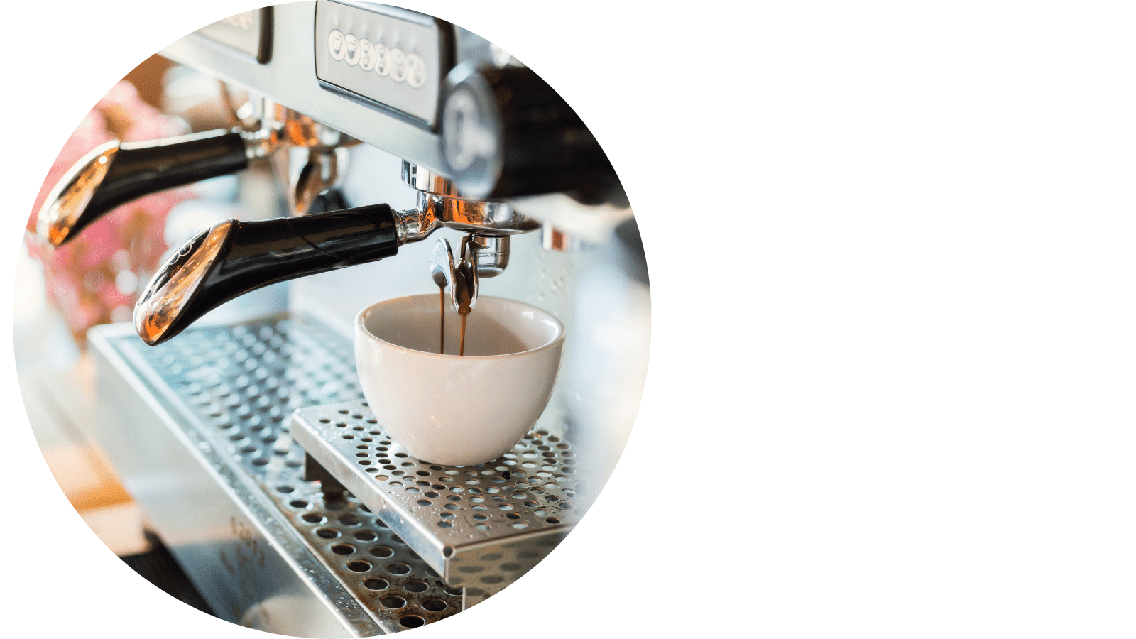 A person filling up a cup of coffee from a commercial coffee machine