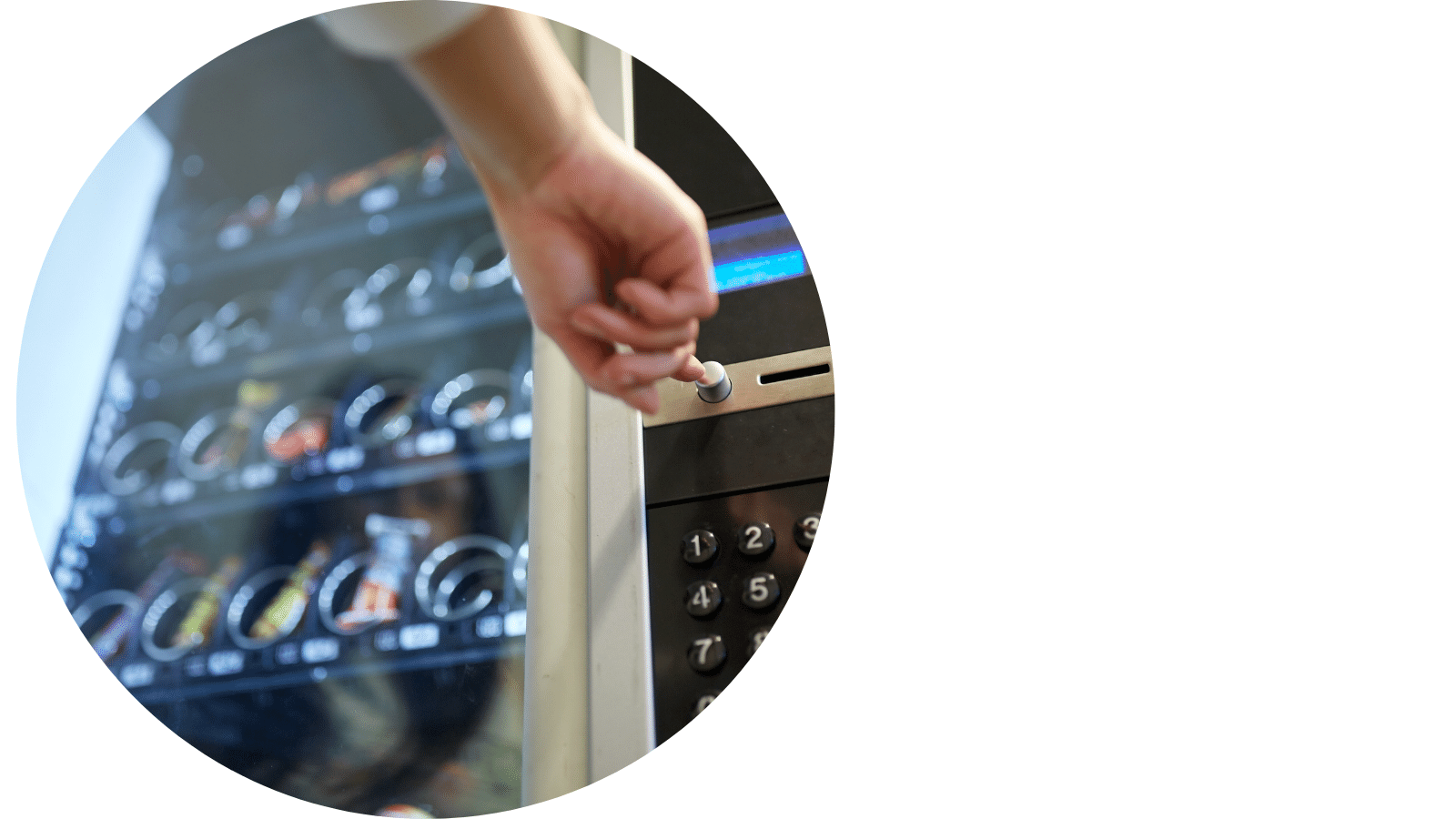 Person pressing a button on the front of a snack vending machine